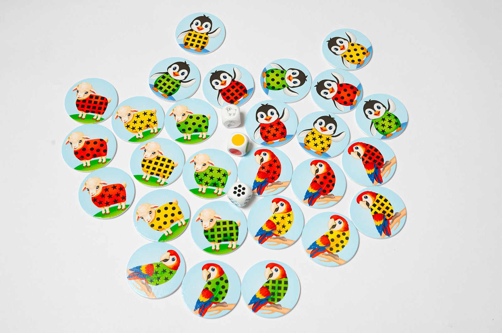 Assortment of colorful animal game pieces surrounding three wooden dice.